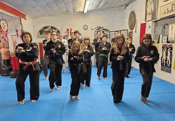 Sensei Nancy Caliguri with black belt students